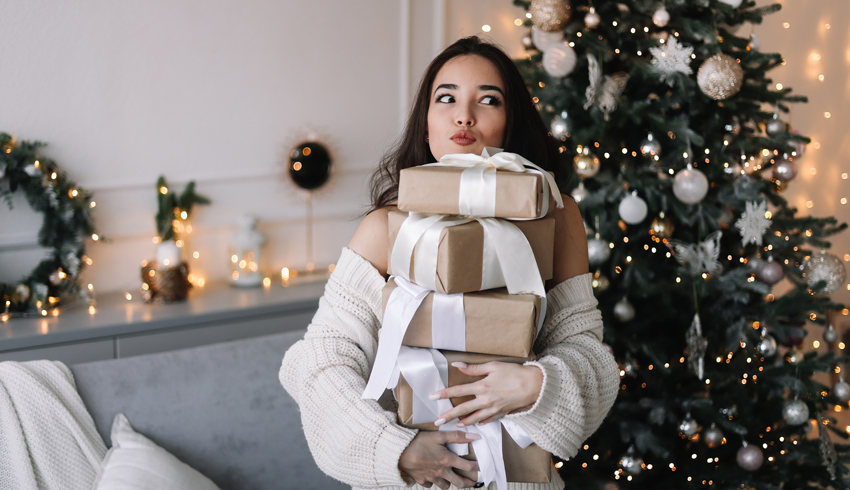 a woman holding a lot of presents